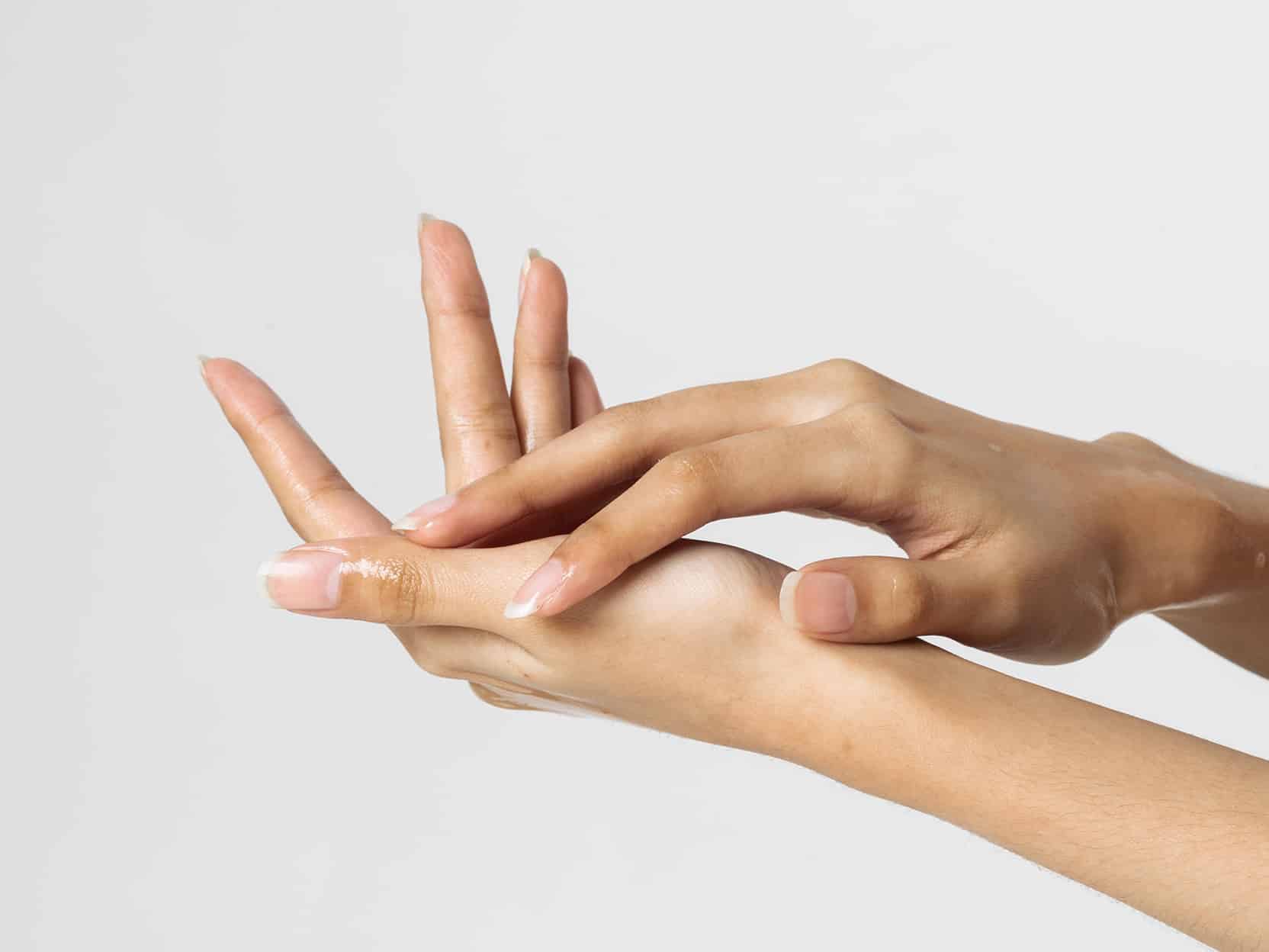 A woman's hands after receiving a Radiesse filler treatment.