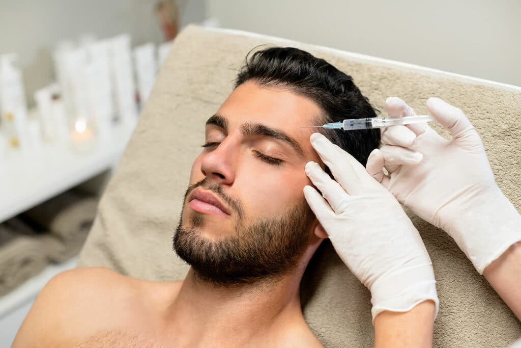 Young man receiving botox injection in Friendswood, TX.